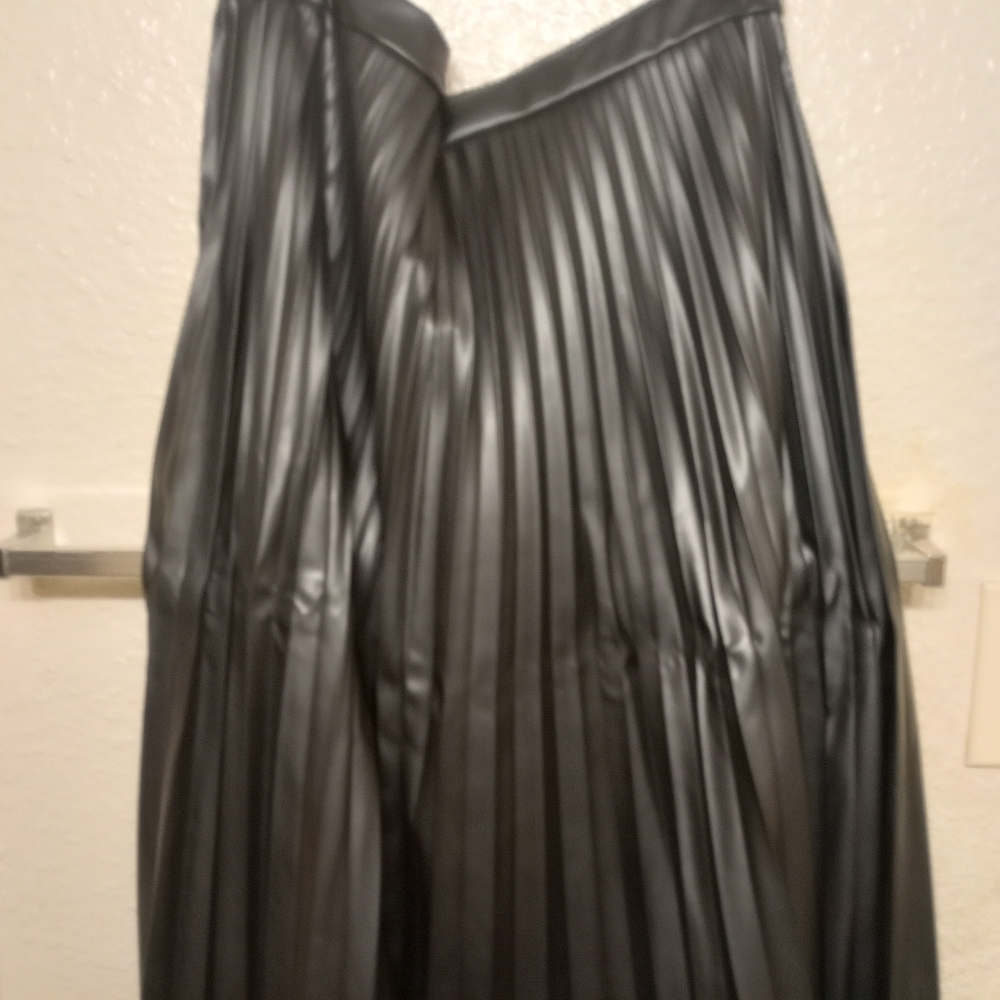 A black, knee length leather skirt